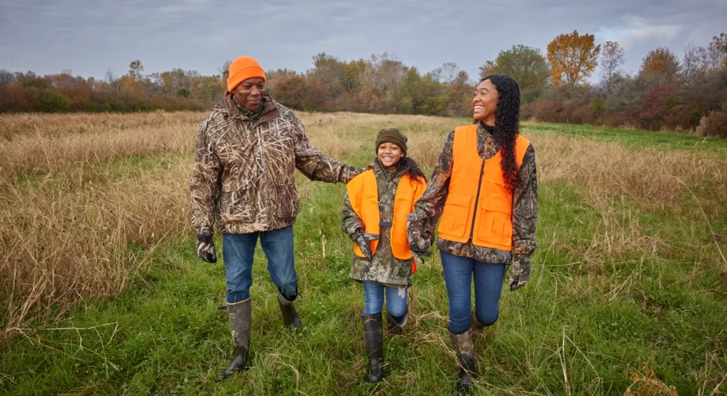 family hunting and walking in a field