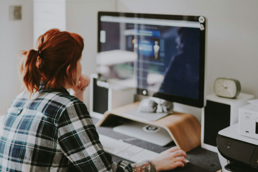 Woman business owner making website updates on computer