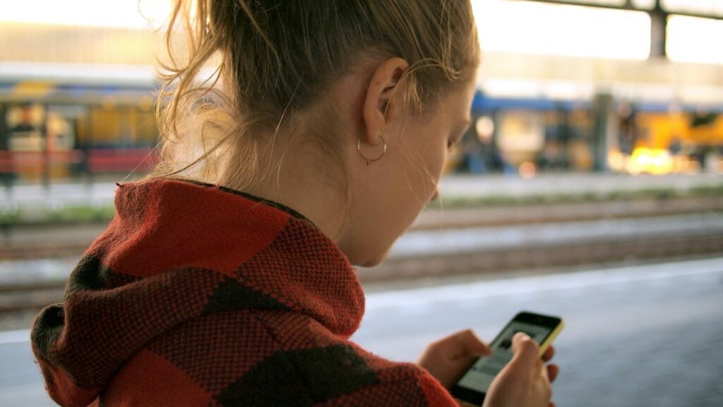 A woman searching for a local business on her phone