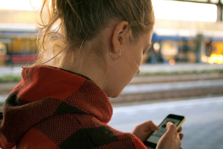 A woman searching for a local business on her phone