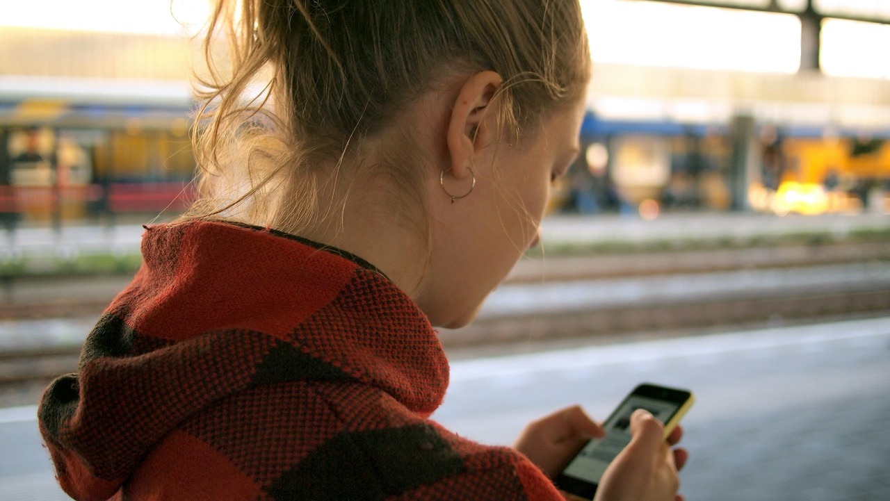 A woman searching for a local business on her phone