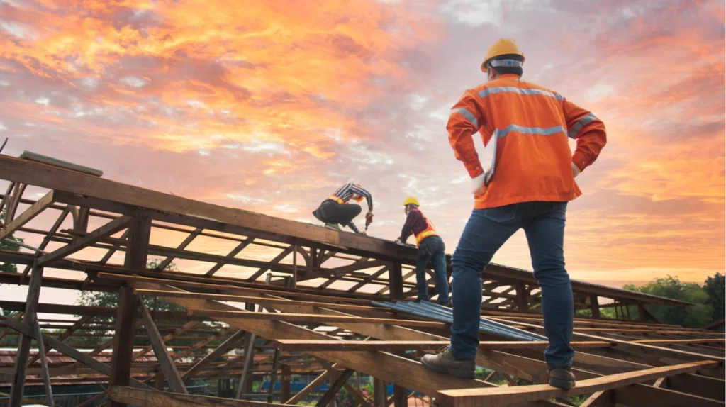 contractor and worker on the roof of a framed out house