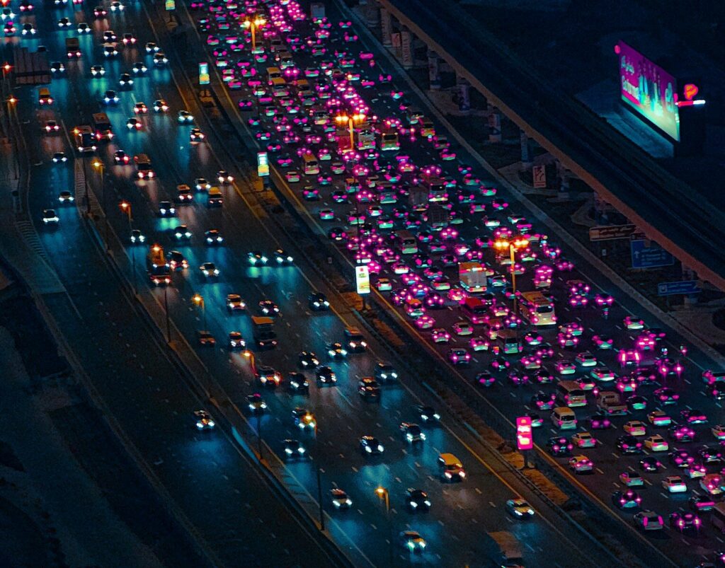 A busy highway filled with lots of traffic at night